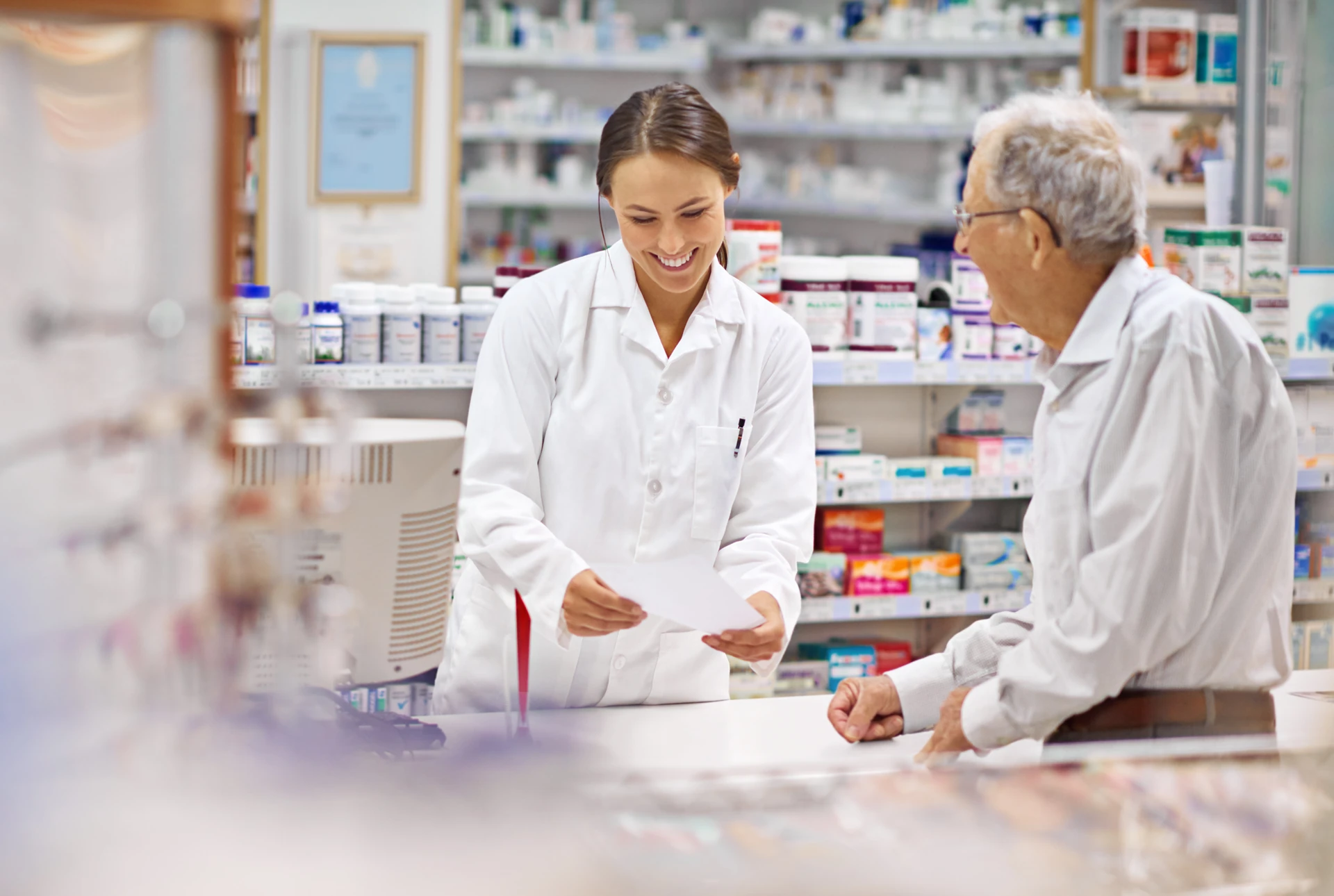 Pharmacist helping customer Pharmacist helping customer